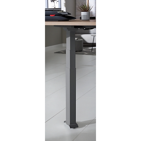 Grey, height-adjustable metal desk leg against a bright background.
