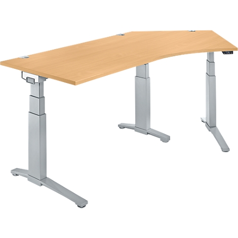 Bureau ergonomique brun clair avec des pieds argentés réglables en hauteur. Le plateau est incurvé et présente un veinage naturel du bois.