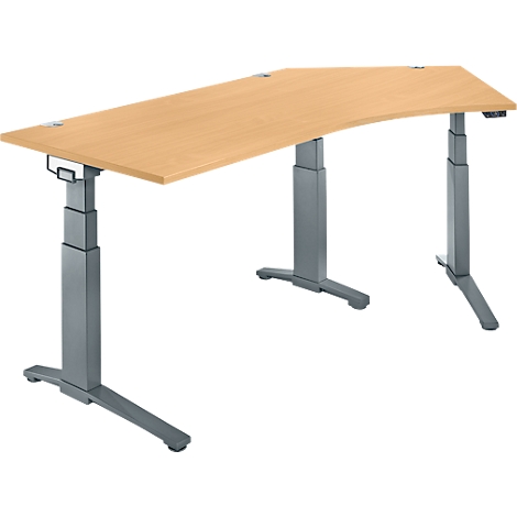Un bureau réglable en hauteur avec un plateau de table brun clair et un cadre gris. Le plateau de table est incurvé.