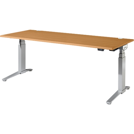 Un bureau réglable en hauteur avec un plateau brun clair et des pieds argentés.