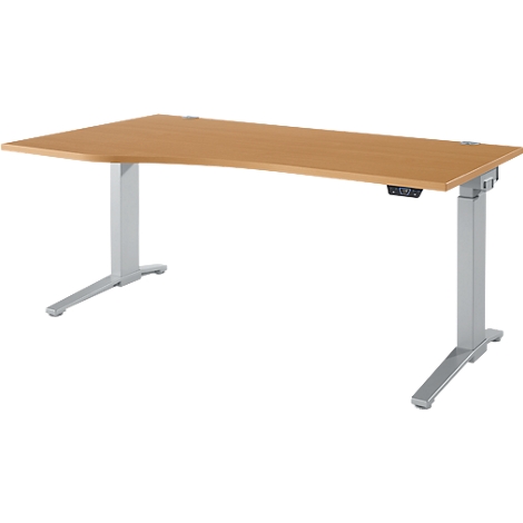 Un bureau réglable en hauteur, brun clair avec des pieds gris. Le dessus de la table a un coin arrondi.