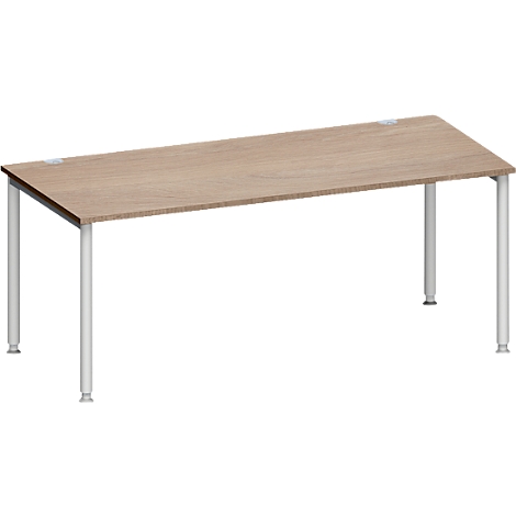 Een rechthoekige bruine houten tafel met witte cilindrische poten.