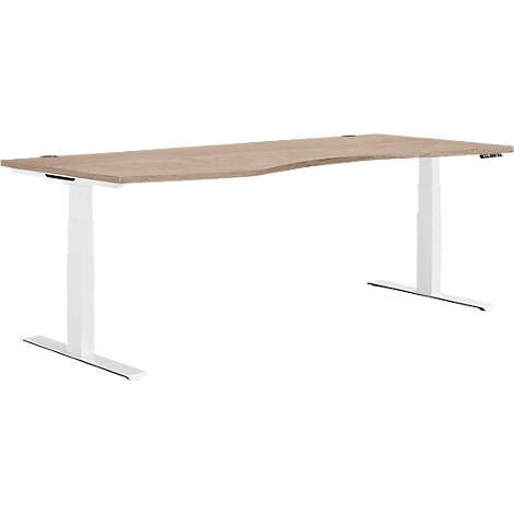 Bureau brun clair, de forme ergonomique, avec des pieds blancs réglables en hauteur. Vue de côté.
