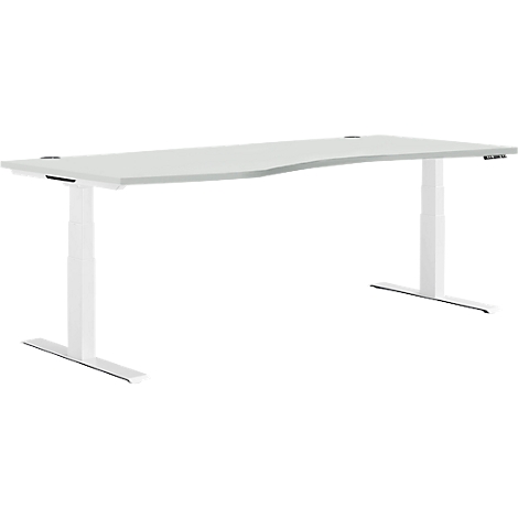 Un bureau blanc réglable en hauteur avec un plateau incurvé. Les pieds sont blancs et en forme de T.