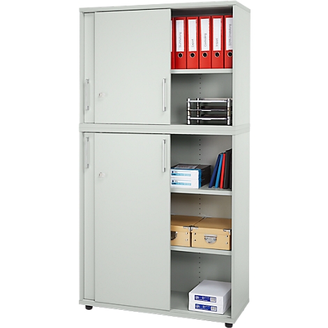 Gray filing cabinet with sliding doors. Red binders on top, papers and boxes below.