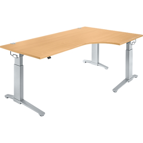 A wooden corner desk with metallic, height-adjustable legs. The tabletop is light brown, the legs are silver grey.