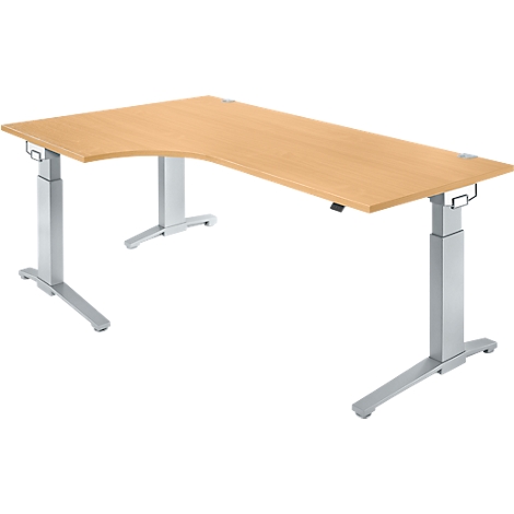 A beige, corner desk with silver, height-adjustable legs. The desk stands against a white background.