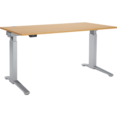 A height-adjustable desk with a wooden top and silver legs. A control unit is mounted on the desk.