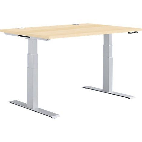 A height-adjustable desk with a light brown tabletop and silver legs. Controls are located on the right.