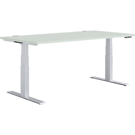 A white, height-adjustable desk with gray legs. There are buttons for height adjustment on one side.