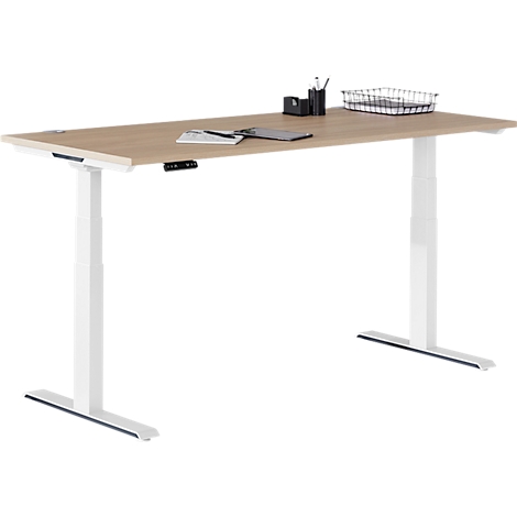 Desk with wooden top and white frame. Some utensils are lying on the table top.