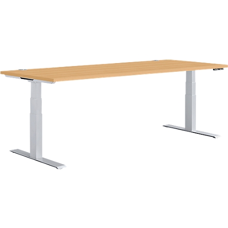 A light brown desk, height adjustable with light grey legs, against a white background.
