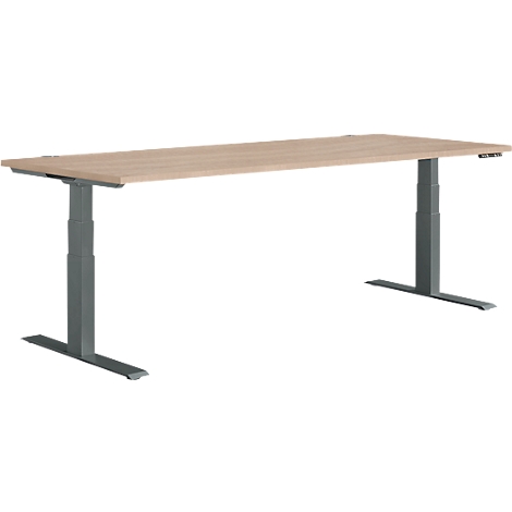 Adjustable height desk, light wood top, gray legs.