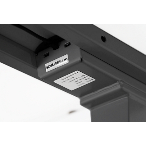 Detail shot: Underside of a desk with USB ports and the Schäfer Shop logo.
