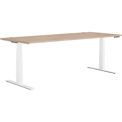 A height-adjustable desk with a light brown tabletop and white legs. The controls are on the side.
