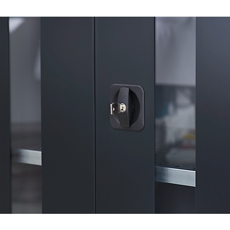 Close-up of a black cabinet door with a rotary handle and inserted key.