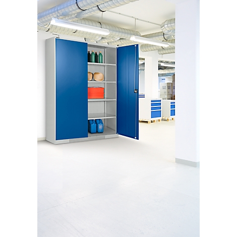 Blue cabinet in a bright warehouse, with doors open. Inside shelves with items like bottles and containers.