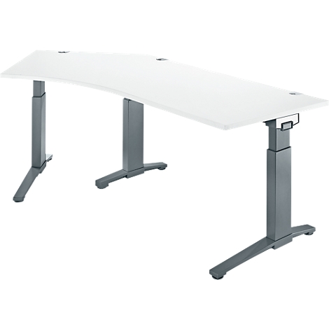 A white, curved desk with gray, height-adjustable legs. There are round openings in the table.