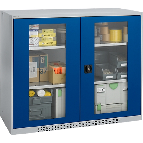 Gray-blue cabinet with glass doors, filled with tools and materials.