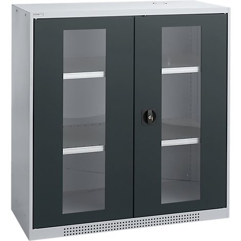 A white wall cabinet with two doors. Dark gray frames surround the glass doors. A lock is in the center.