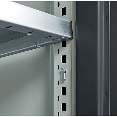 Close-up of a metallic shelving system. A silver shelf is held by a metal bracket, details.