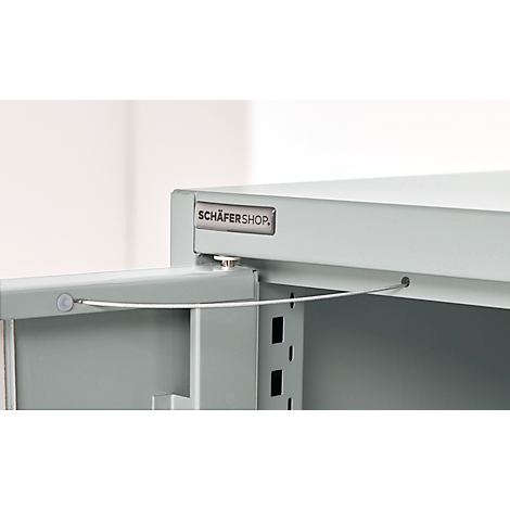 Close-up of a grey cabinet with an open door and a 'SCHÄFERSHOP' sign.
