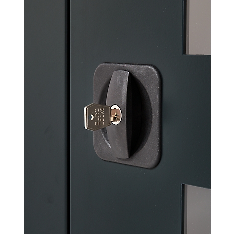 Close-up of a dark cabinet lock with key. The key is inserted into the lock.