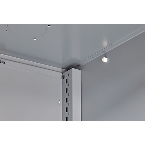 Inside view of a cabinet: angles and brackets. Light source on the ceiling.