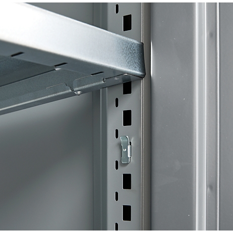 Close-up of a metal shelf mounted in a light gray cabinet. The gray metal construction shows a shelf bracket.