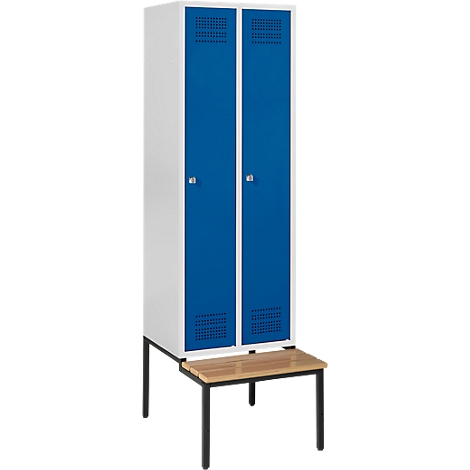 A white cabinet with two blue doors, on a brown bench with black legs.