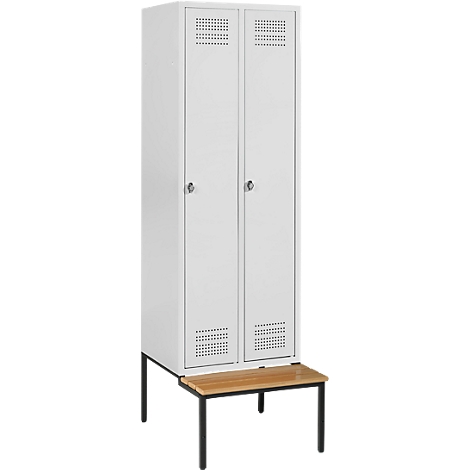 A white locker with two doors and ventilation holes. Underneath is a brown seat on black legs.