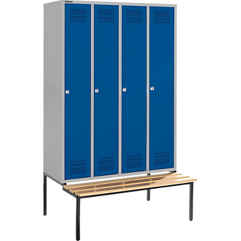 Locker with four blue doors and a wooden bench.