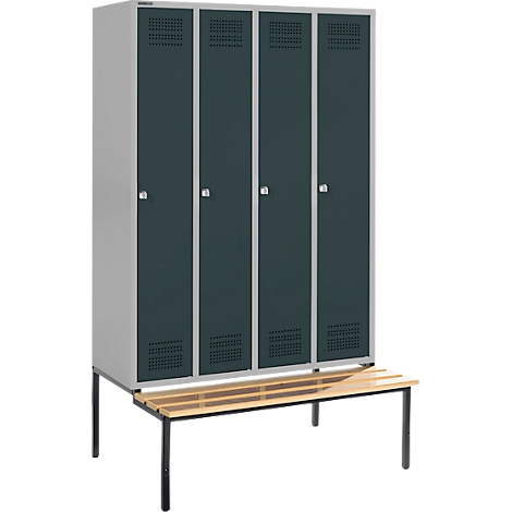 A grey metal locker with four doors and a wooden bench. The doors have ventilation slots and silver handles.