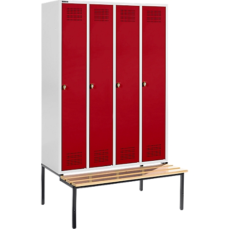 Cabinet with four red doors and perforated surface. Underneath, a wooden bench with a black frame.