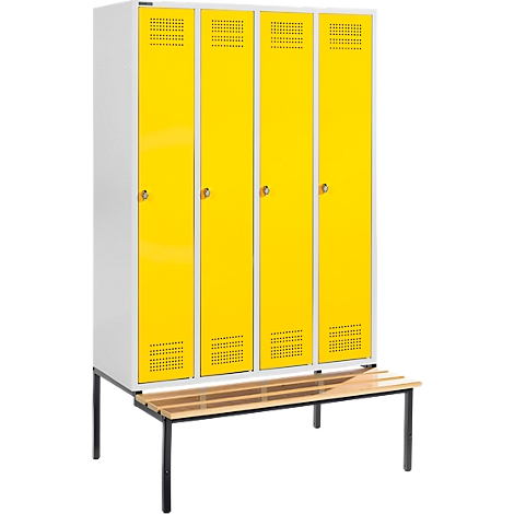 A locker with four yellow doors and a wooden bench in front.