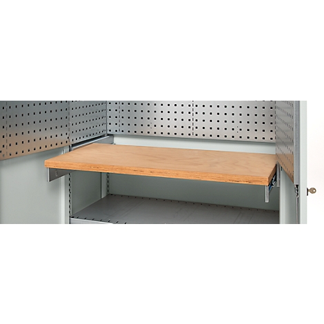 A wooden shelf is mounted on metal brackets inside a cabinet, with a pegboard above it.
