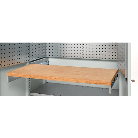 Wooden panel as an extension in a workshop cabinet, with a perforated panel wall behind.