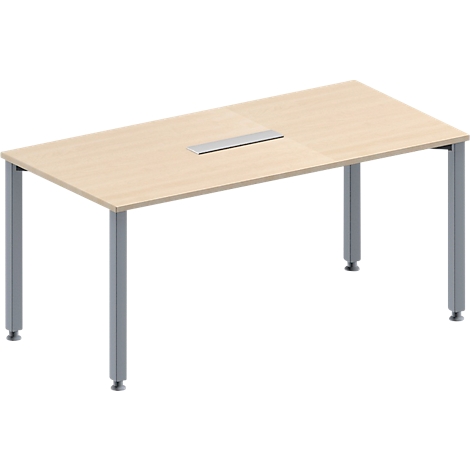 Rectangular, light brown table with silver-gray legs. There is a rectangular recess in the table top.