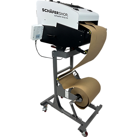 Papieren verpakkingsmachine, grijs frame, bruin papier. Schäfer Shop logo.