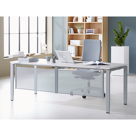 A modern desk with a laptop, chair and books in front of window and bookcase.