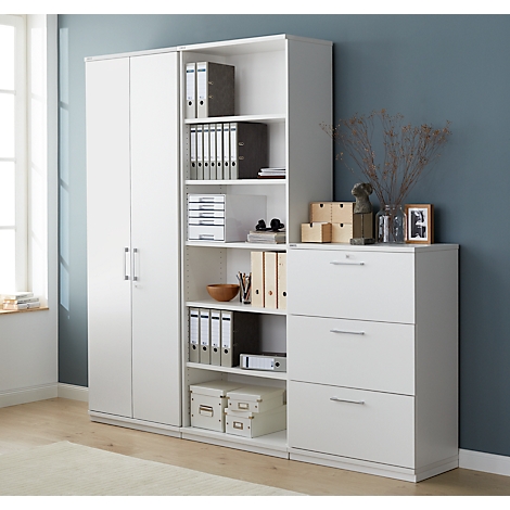 White office cabinet with closed cabinet, open shelving and drawers. Shelves hold binders, boxes, and decorations.