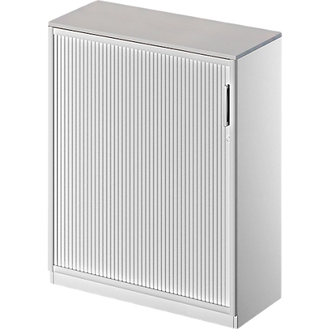 White cabinet with a roller shutter front. The cabinet has a smooth top and bottom, the front is ridged. There is a black handle on the right.