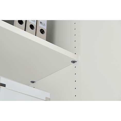 Light beige shelves with gray pins on a white wall. Folders are on the top shelf.
