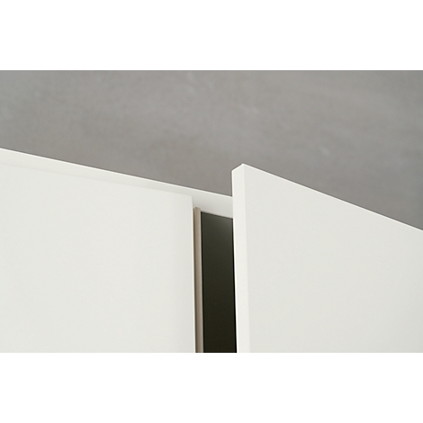 Close-up: White cabinet doors, open, with dark interior against a gray background.