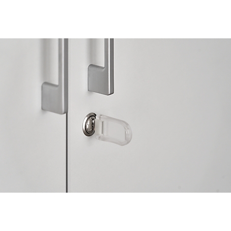Close-up of a white cabinet door with handles and a lock. A clear key is in the keyhole.