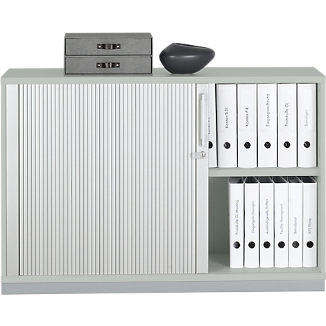 Gray filing cabinet with sliding door and white binders on the shelf.