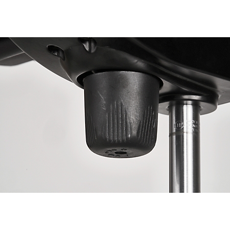 Close-up of the underside of a chair. A cylindrical, ribbed element surrounds a metal tube.