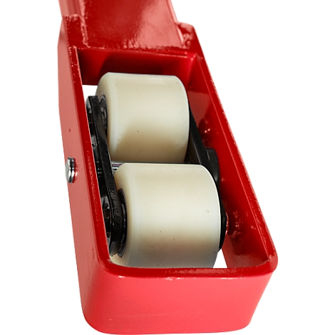 Close-up of two white rollers in a red metal frame.