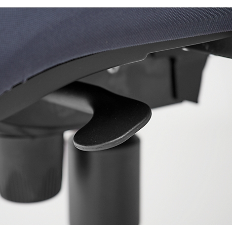 Close-up of a black lever device under a dark blue textile. In the background, a black column is visible.