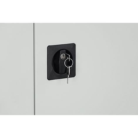 Detail shot: Black lock with keys on a gray door.